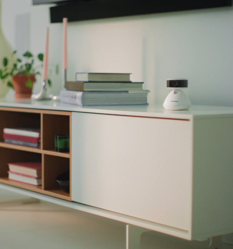 Petlibro PETLIBRO pet camera on white cabinet with books and plant; smart cat litter box monitor device in home setting