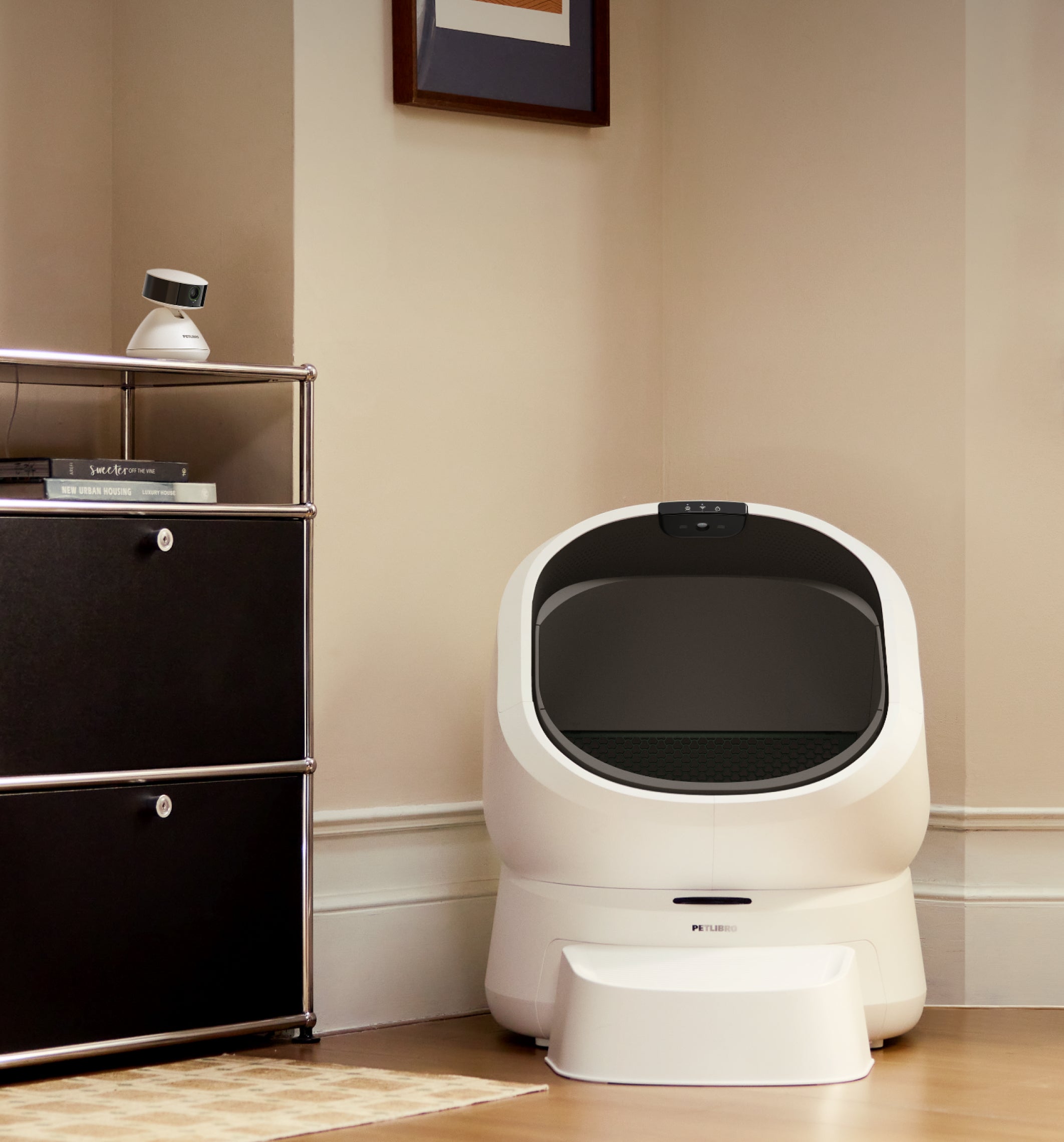 Petlibro automatic self-cleaning cat litter box in white with black interior and step stool in a home corner setting