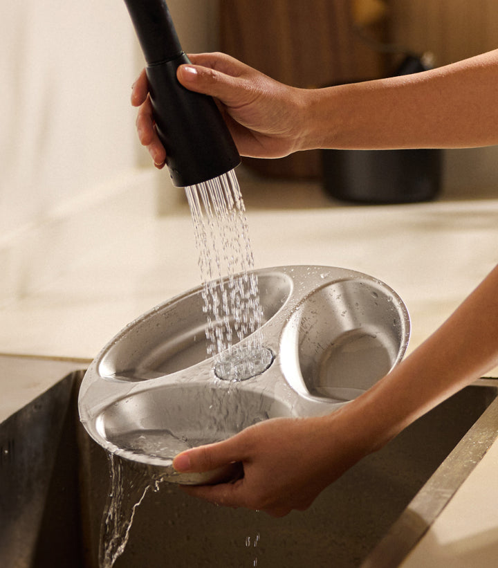 Petlibro PETLIBRO pet litter box accessory tray rinsed under faucet, gray plastic insert with two oval basins in sink