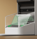 Petlibro automatic pet feeder close-up showing transparent sliding food compartment with green arrows indicating movement direction