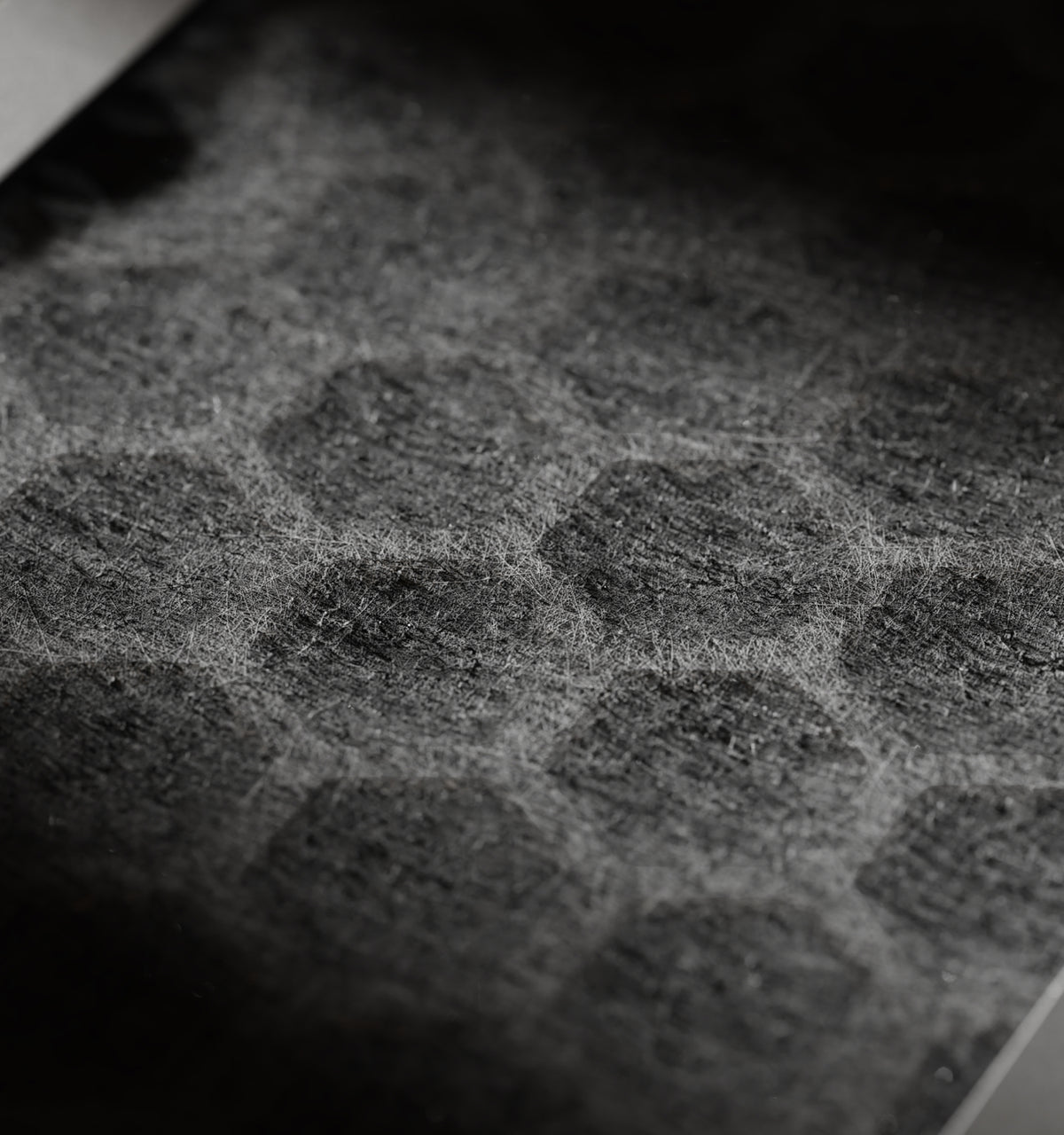 Petlibro close-up of a black textured pet grooming mat covered with light-colored pet hair fibers