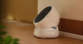 Petlibro automatic self-cleaning cat litter box in white with sleek oval design placed on wooden floor
