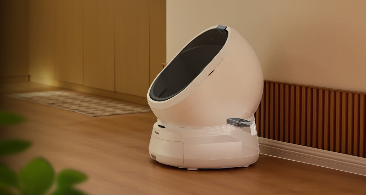 Petlibro automatic self-cleaning cat litter box in white with sleek oval design placed on wooden floor