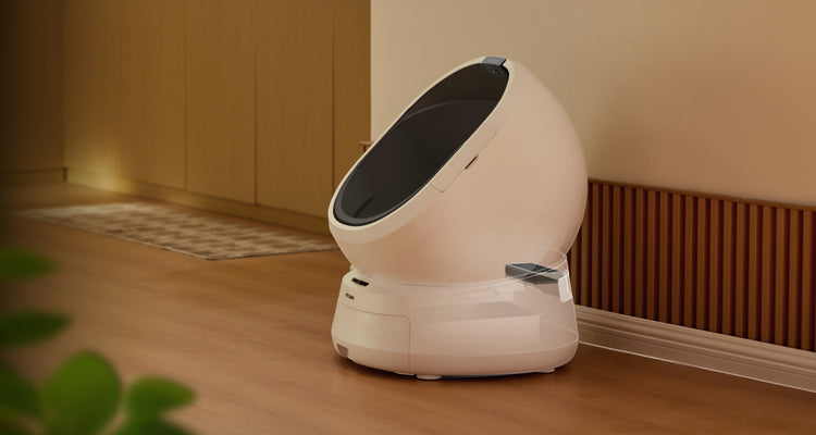 Petlibro automatic self-cleaning cat litter box in white with sleek oval design placed on wooden floor