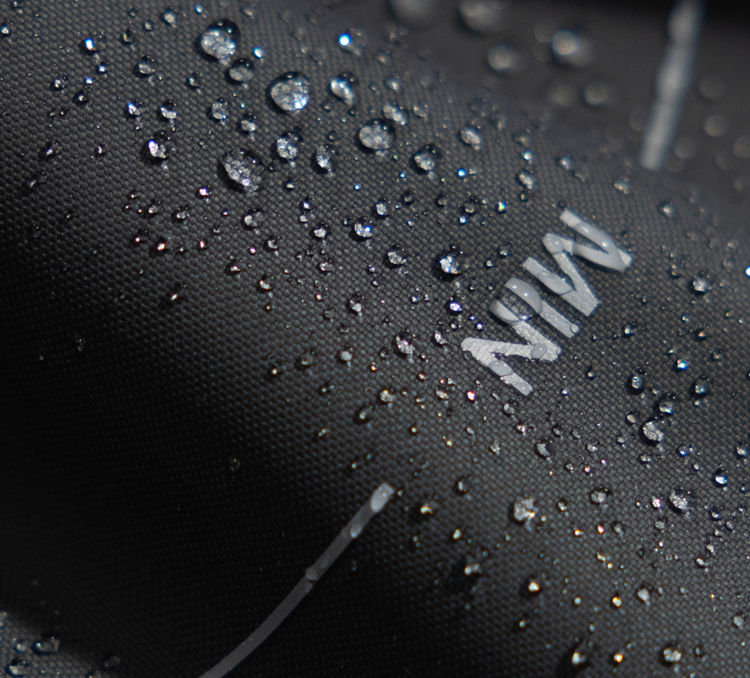 Petlibro close-up of black waterproof fabric with water droplets highlighting water resistance feature