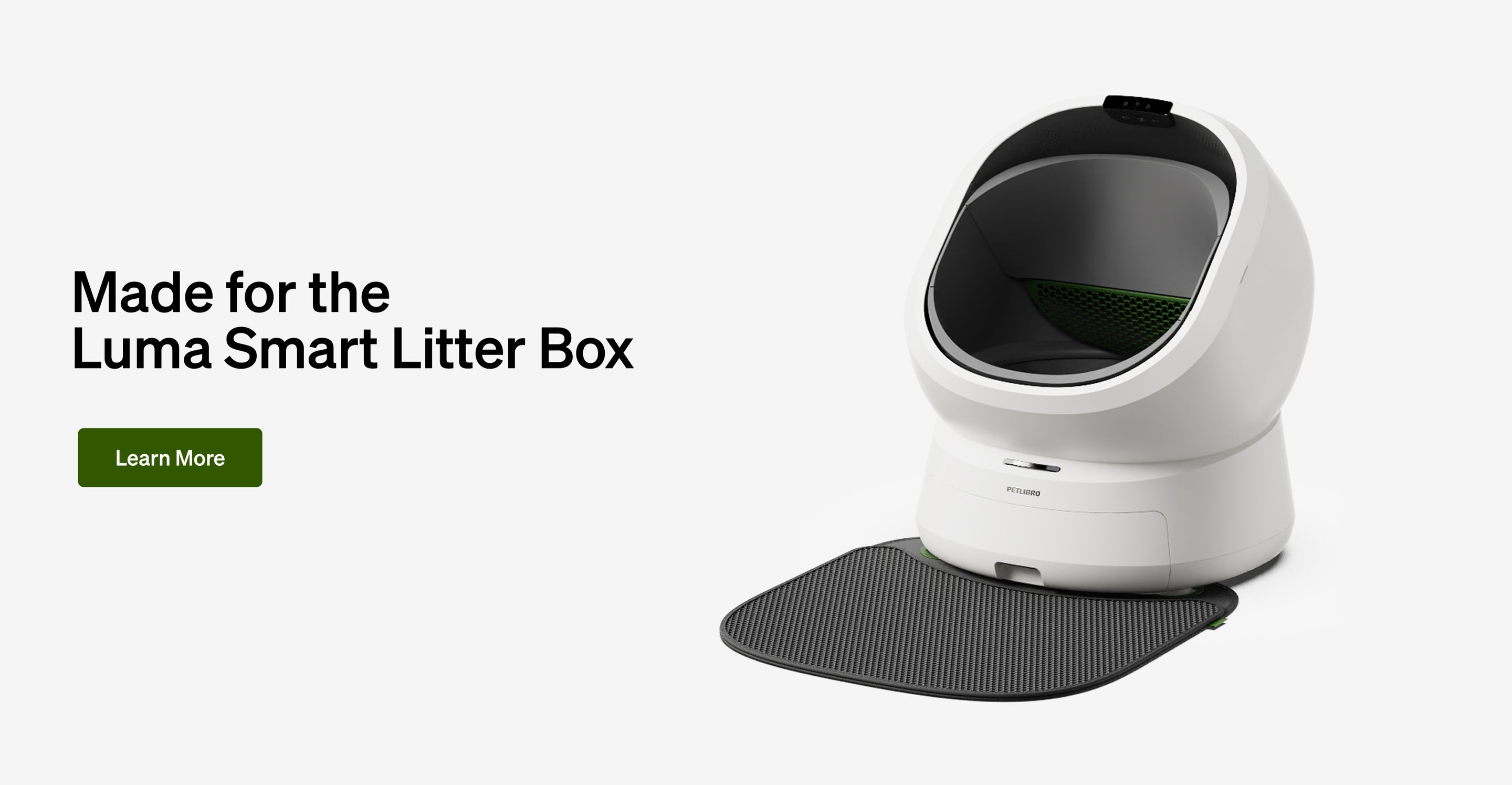 Petlibro Luma Smart Litter Box in white with black and green interior and attached textured black mat