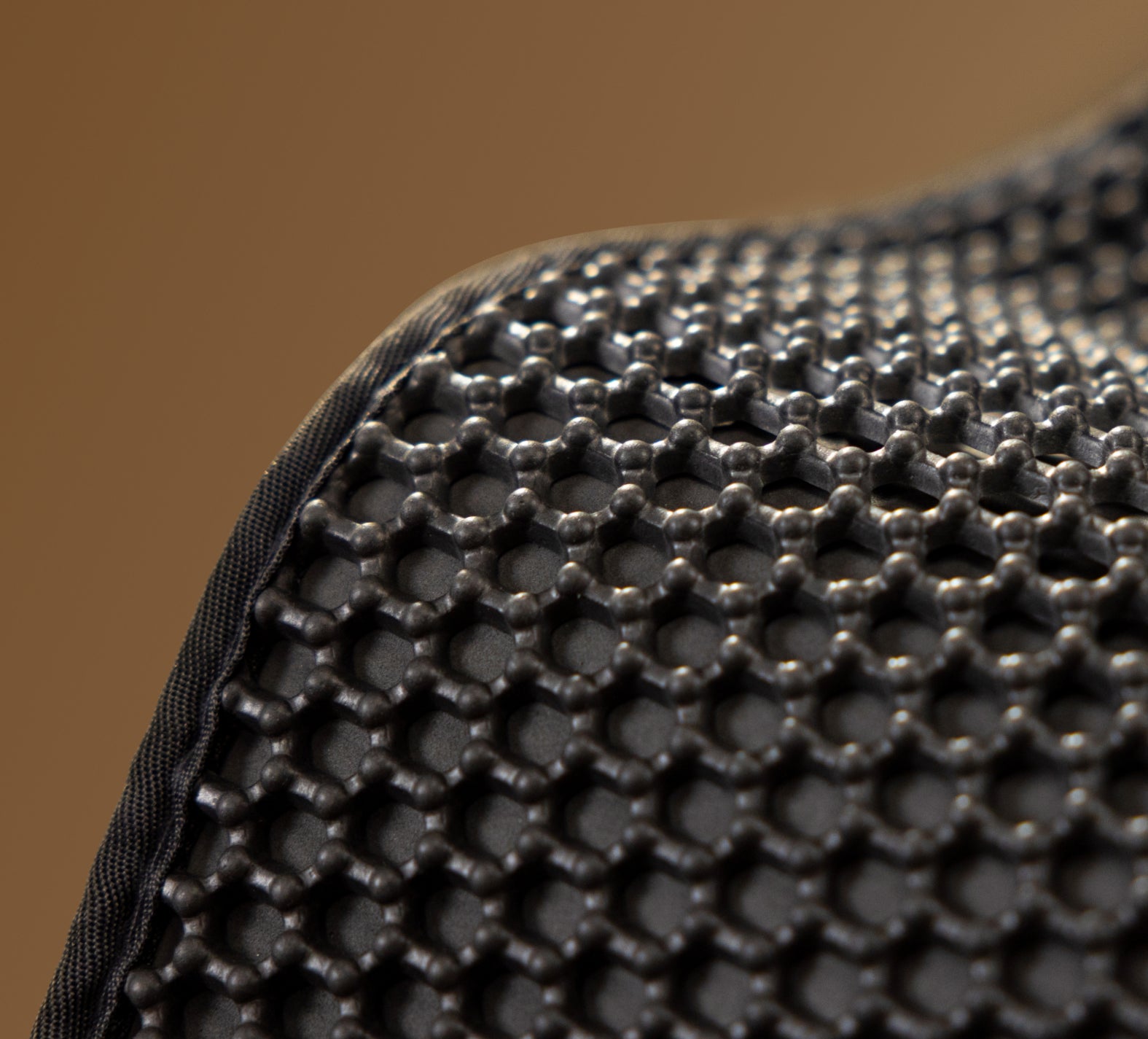 Petlibro close-up of black honeycomb-patterned textured surface with rounded edges, likely part of a pet accessory or mat