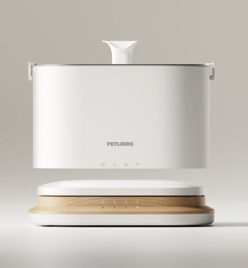 Petlibro PETLIBRO pet litter box system, white rectangular unit with top vent and wood-base control dock on beige background