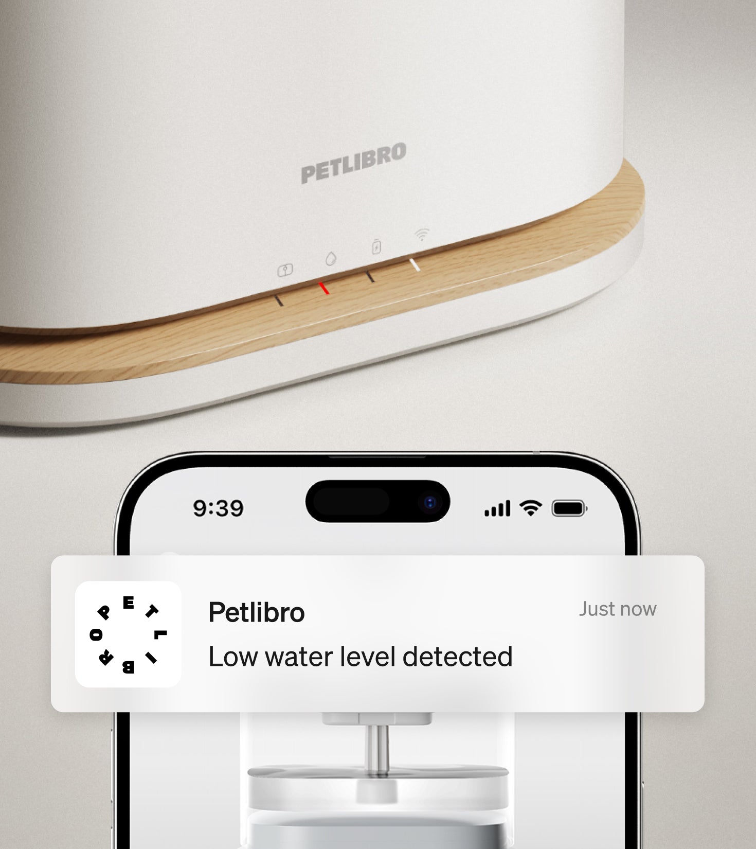 Petlibro PETLIBRO pet litter box alert on phone, white device with wood trim; cat care notification shown on screen