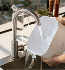 Petlibro PETLIBRO pet litter box for cat, white tray rinsed under kitchen faucet, water pouring out for easy cleaning